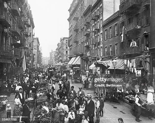 Mulberry Street in New York City ca crowded with life. Photograph.