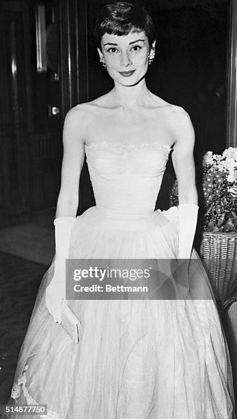 London, England: Audrey Hepburn arriving at the premiere of "As Long As They Are Happy" at the Odeon Leicester Square Theatre tonight. INP London...