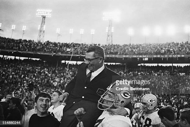 Green Bay Packers head coach Vince Lombardi gets a victory ride off the field on the shoulders of his players after the Packers smashed the Oakland...
