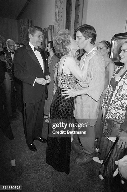 President Ronald Reagan looks on as a proud First Lady kisses their son, Ron, following a performance of the Joffrey Ballet. The performance was the...