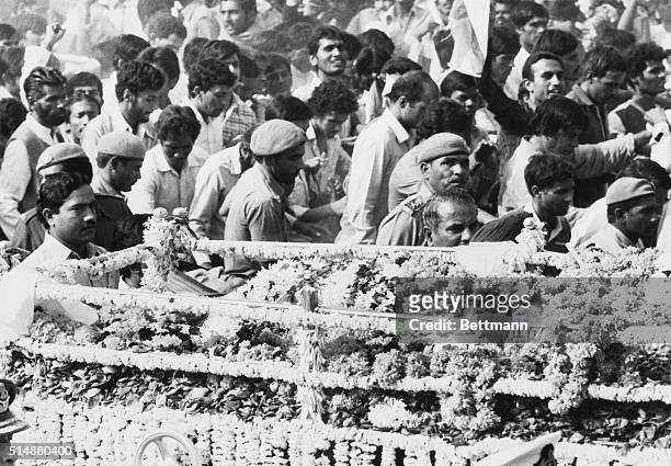 Mourners walk with the bier of Prime Minister Indira Gandhi, on its way to cremation, New Delhi, India, 3rd November 1984. Gandhi was assassinated by...