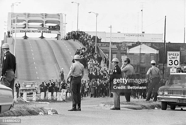 State troopers watch as marchers cross the Edmund Pettus Bridge over the Alabama River in Selma, Alabama as part of a civil rights march on March 9....