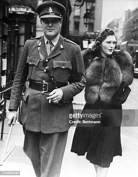 London, England: Churchill's son strolls in London. Randolph Churchill, son of the British Prime Minister, strolling in London with his wife, the...