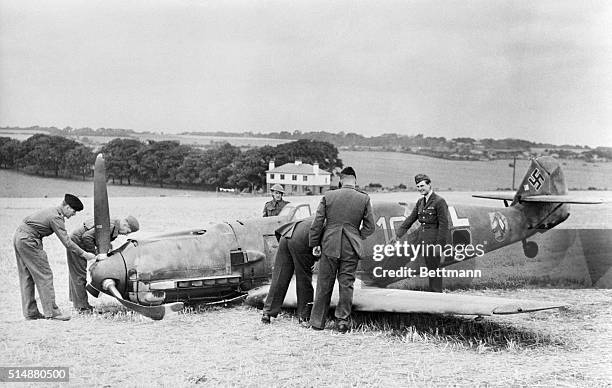 The Messerschmitt Bf 109E-4 'Yellow 10' of Unit 6 Jagdgeschwader 51 'Molders' piloted by Oberfeldwebel Fritz Beeck is examined by the local defence...