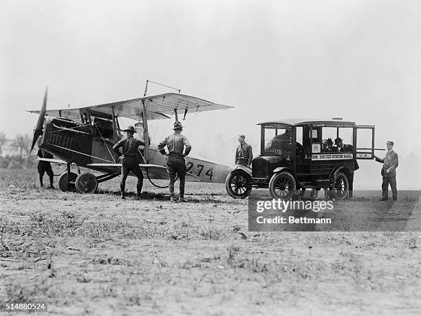 May 1918-Philadelphia, PA: Opening of aerial mail service in Philadelphia, PA. Transfer of mail bags from U.S. Mail wagon to the airplane about to...