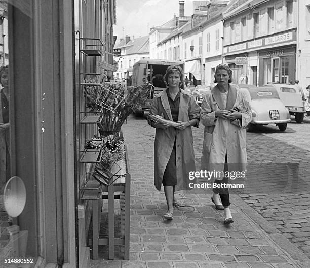 Chevreuse, France: Just like every housewife here, Swedish actress Ingrid Bergman does her shopping at teh local market with the aid of her daughter...