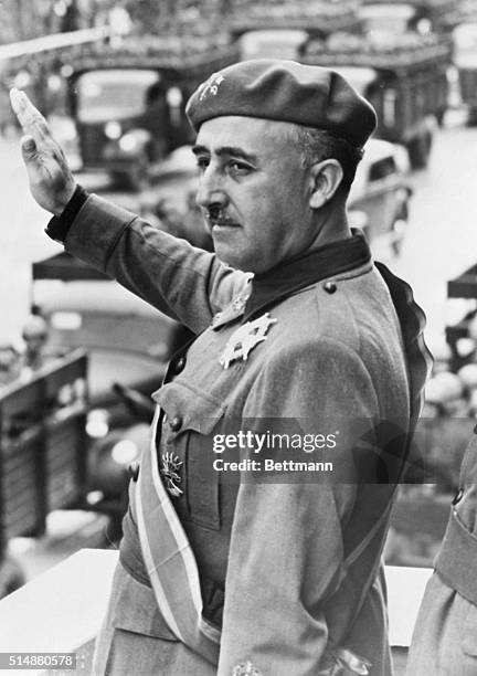General Francisco Franco, leader of the fascist troops during the Spanish Civil War, and future dictator of Spain, giving the fascist salute and...