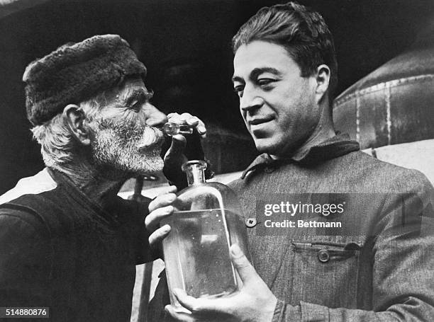 The taste of smell. Expert perfumer smells samples from newly made rosewater. Valley of the roses. Bulgaria. Undated photograph. BPA2# 3627