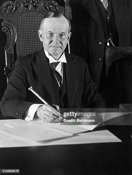 President Calvin Coolidge seated at his desk. Undated.