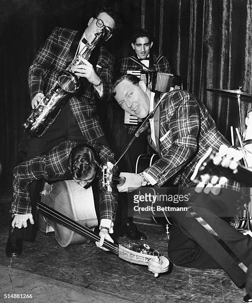 Don't just play-Do something! "That's the advice Bill Haley gives to his "Comets". Here they are doing just that during a rehearsal at the Dominion...