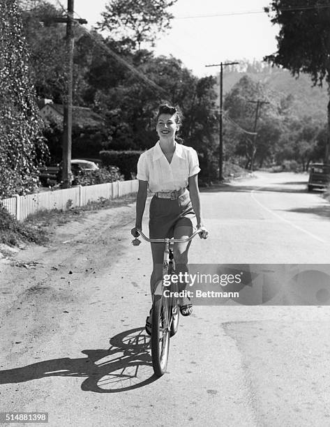 Ava Gardner , MGM star on bicycle. Photo 10/28/52.