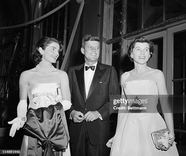 New York, NY: Senator and Mrs. John Kennefy and Mrs. Robert Sargent Shriver are pictured tonight at the "April in Paris" Ball at the Waldorf Astoria....