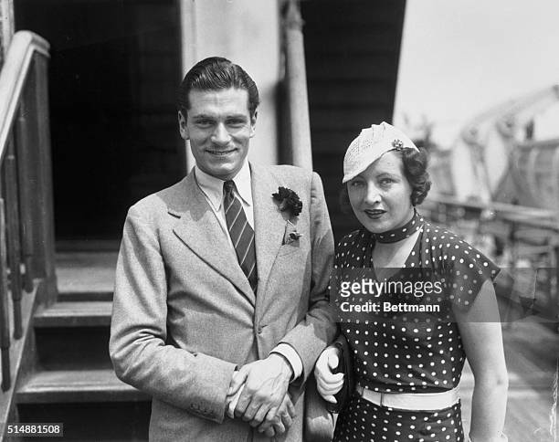 New York, NY: Laurence Olivier, English actor, shown with Mrs. Olivier as they arrived in New York City, July 20, abaord the S.S. Europa. Olivier is...