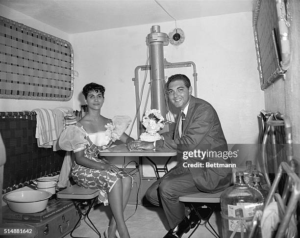 Miami, FL: Setting up housekeeping in an underground bomb shelter, newlyweds Melvin Minnison and Maria Rodiguez hold hands as they begin their...