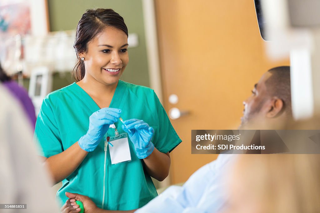 Hospital phlebotomist preparing to collect blood donation from patient