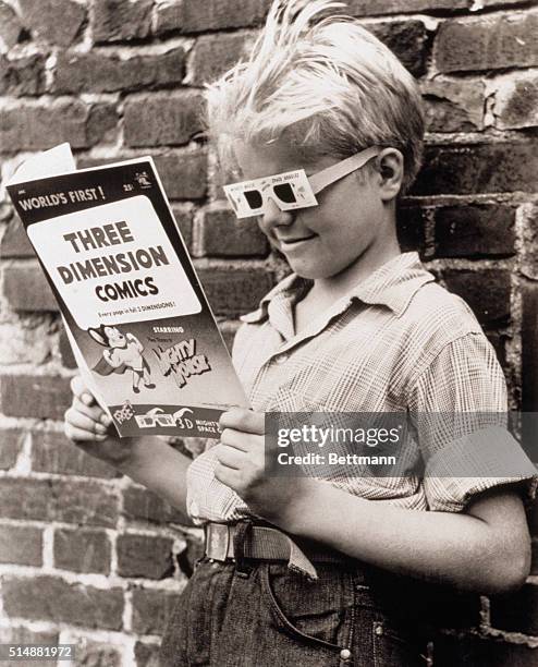 Wolfgang Routa, age 10, is enthralled by the latest fad, comic books in 3-D, New York, 1953.