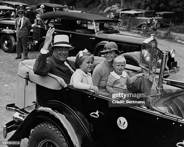 President Franklin D. Roosevelt goes for a ride in his automobile with his daughter Anna Roosevelt Dall, granddaughter, "Sistie", and grandson...