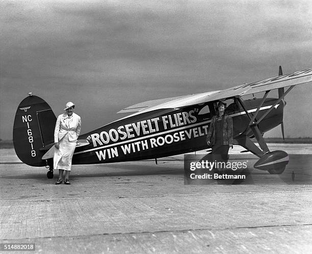 Mrs. Oxlie, the chairwoman of the Commitee of Women Aviators for President Roosevelt and assistant Attorney General Stella Akin standing with one of...