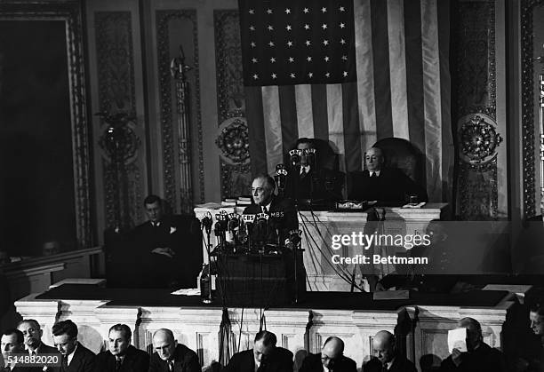 Vice President Henry Wallace and House Speaker Sam Rayburn look on as President Franklin D. Roosevelt addresses a joint session of Congress on...