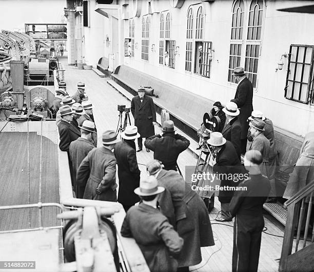 New York, NY: Former Chancellor of the British Exchequer Winston Churchill, surrounded by reporters on the S.S. Bremen, when he arrived in New York...