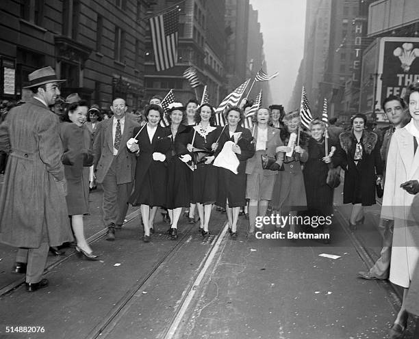 New York, NY: Women Carry flags down stret to celebrate V-E day.