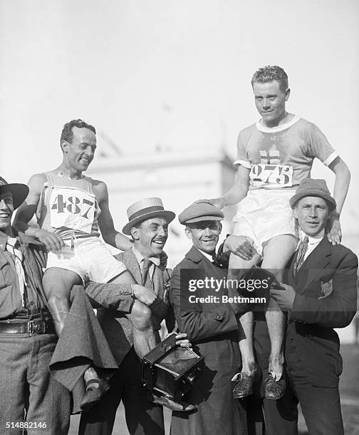 Antwerp Olympics: Paavo Nurmi of Finland finishing first in 10,000 metre race and running mate Maccario of Italy who finished fourth on the shoulders...