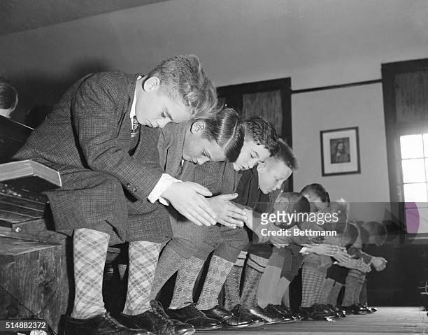 New York Juvenile Asylum: peep at a class during Sunday School at the Village. The boy Fourth from the left is reading the prayer. His fellow...