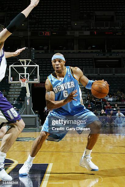 Kenyon Martin of the Denver Nuggets dribbles against the Milwaukee Bucks during the NBA Preseason game at the Bradley Center on October 16, 2004 in...