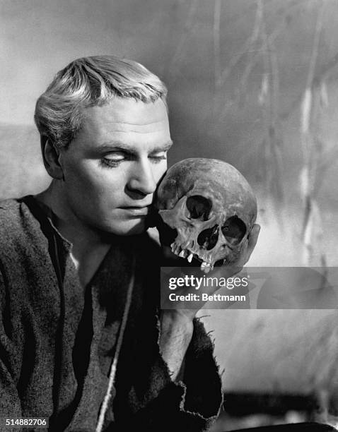 Laurence Olivier, as Shakespeare's Prince Hamlet of Denmark, holds the skull of Yorick in a scene from his film version of "Hamlet."