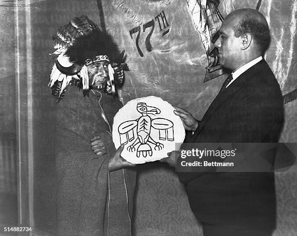 Chief Black Eagle, Mohawk Indian member of famous 77th Division in France, gives adobe plaque of the original "Thunder Bird" from which the NRA Eagle...