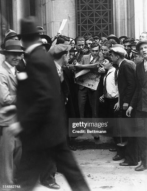 Brokerage house customers wait at the entrance to the New York Stock Exchange after the stock market crashes on October 24.