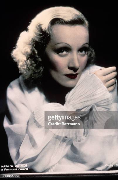Publicity still of Marlene Dietrich wearing white blouse. Undated hand tinted photograph.