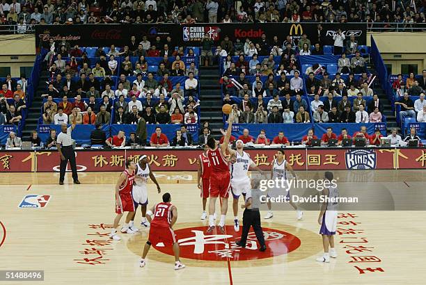 Yao Ming of the Houston Rockets and Brad Miller of the Sacramento Kings tip off the preseason game between the Houston Rockets and the Sacramento...