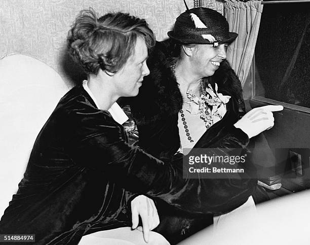 On a short flight to and from Baltimore, aviator Amelia Earhart points out the White House to resident First Lady Eleanor Roosevelt. | Location:...