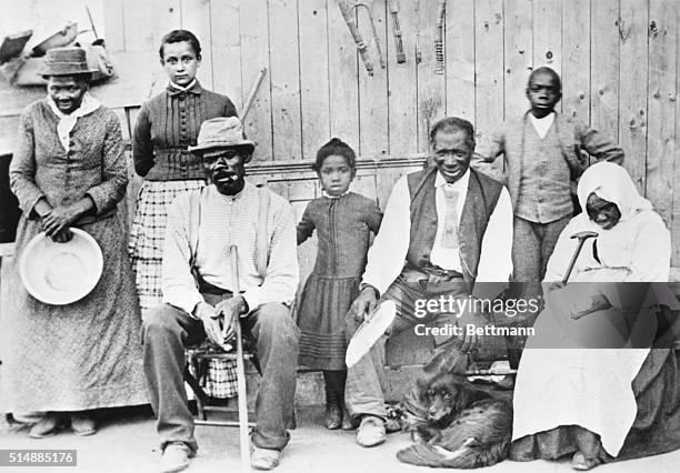 Portrait of American abolitionist Harriet Tubman as she poses with her family, friends, and neighbors on her porch, Auburn, New York, mid to late...