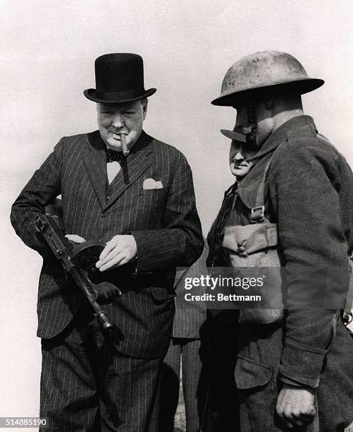 Prime Minister Winston Churchill inspects an American Tommy gun during a 1940 tour of defenses along England's northeastern coast.