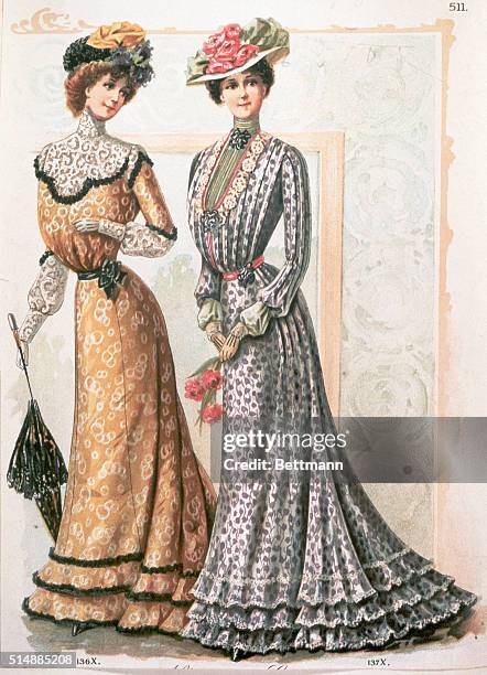 TWO FASHIONABLY DRESSED WOMEN FROM THE VICTORIAN ERA. THEY ARE WEARING LONG, HIGH-COLLARED DRESSES AND FLOWERED HATS. ONE WOMAN IS HOLDING A PARASOL...