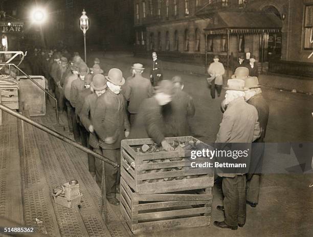 Unemployed men on bread line during the Depression. B/W photograph, undated.