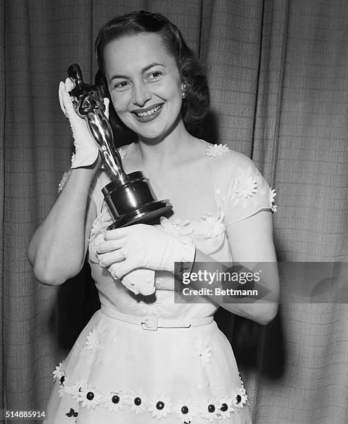 Hollywood, California: Actress Olivia De Havilland proudly displays her second "Oscar," awarded for her performance as the Best Actress of 1949 for...