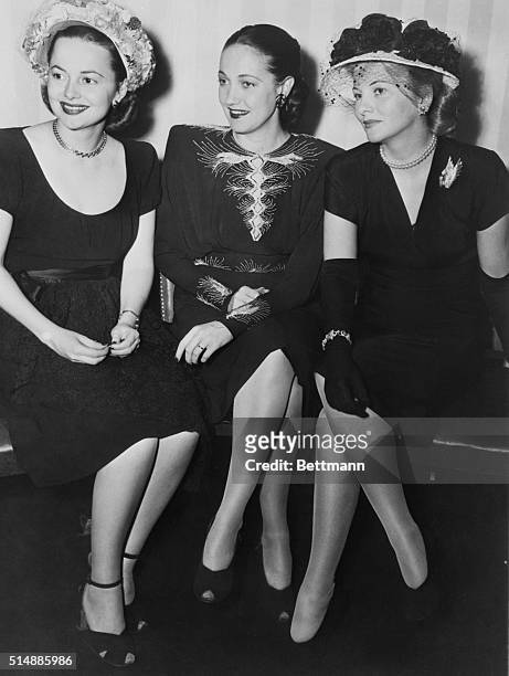 Actresses Olivia de Havilland, Dorothy Lamour, and Joan Fontaine attend a farewell party in their honor at the Stork Club before heading off to the...