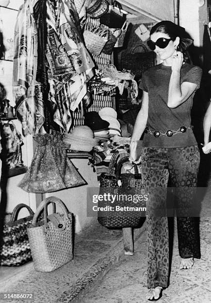 Jacqueline Onassis does some shopping on the Isle of Capri during a Mediterranean pleasure cruise with her husband, Aristotle Onassis, on his yacht...