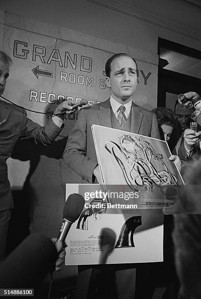 Deputy District Attorney Vincent Bugliosi displays a large photograph of the 43-foot nylon strand cord found draped around the necks of actress...