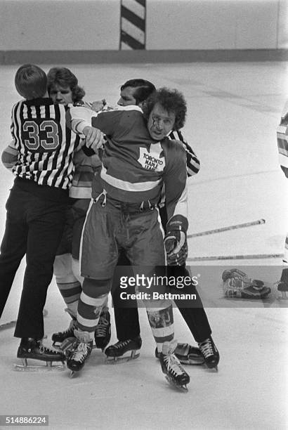 Toronto Maple Leafs' Brian Glennie come away with a bloody face after linesmen Swede Knox and Ron Finn broke up a fight between Glennie and St. Louis...