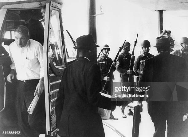 Two black 'Freedom Riders' get off their bus only to face a line of National Guardsmen with fixed bayonets who had orders to maintain order here,...