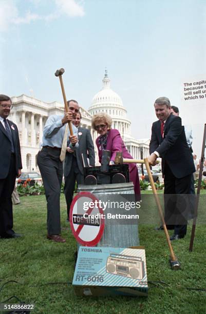 Lawmakers use sledghammers to smash a Toshiba radio on the grounds of the U.S. Capitol. They were protesting the sale by a Toshiba subsidiary of...