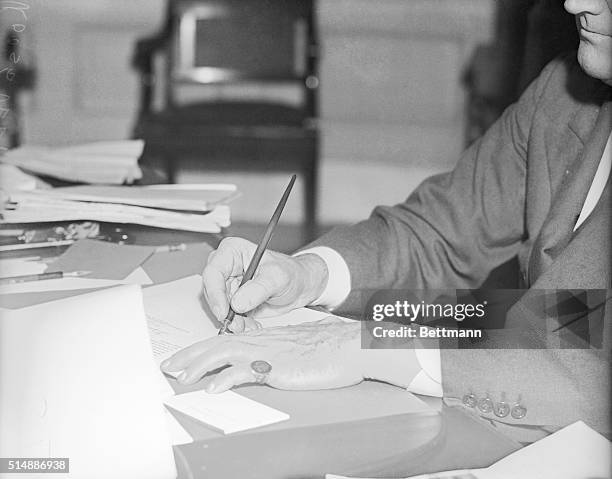 These are the hands which guide the New Deal. Powerful hands of a big man. They belong to President Roosevelt--large hands, though not out of...