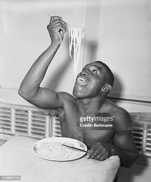 Big helping of spaghetti offers no problems to lightweight champion Jimmy Carter during a meal at his training camp as he prepares for his March 5th...