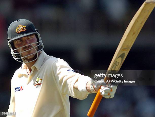 Australian cricketer Damien Martyn acknowledges the crowd's applause as he returns to the pavilion after he was dismissed during the fourth day of...