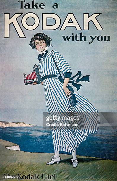 Advertisement for Kodak cameras featuring "The Kodak Girl" well dressed, and standing on a windswept cliff with camera in hand.