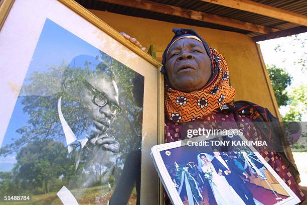 Sarah Obama shows a potrait picture of her late son Barack Hussein Obama [L] and a photo of her grandson's wedding, Barak Obama, the Illinois state...